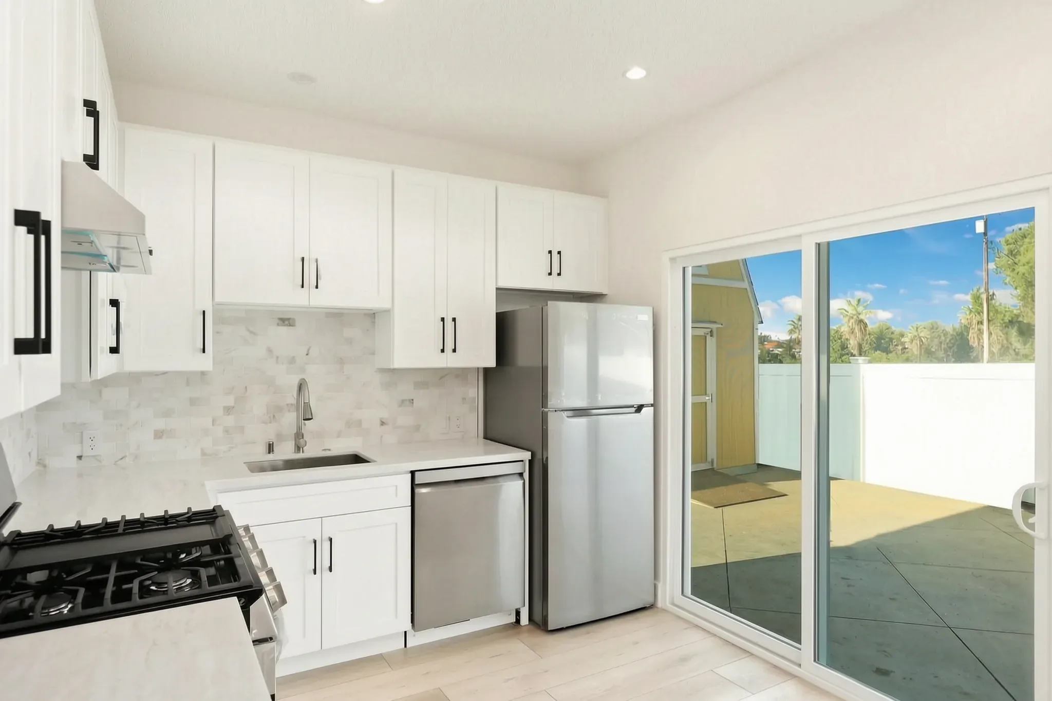 Garage conversion ADU — kitchen with slider to the yard, Brea, Avorino